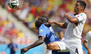 Balotelli is being tightly marked by the Costa Ricans. Michael Umana grabs his shirt