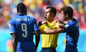 Mario Balotelli is booked by referee Enrique Osses.
