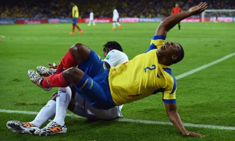 Ecuador's Jorge Guagua is clattered by Carlo Costly of Honduras.