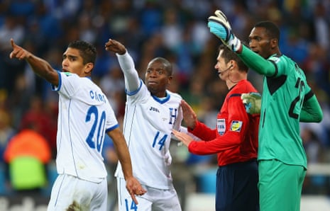 Jorge Claros and Oscar Boniek Garcia, second left, plead with referee Benjamin Williams to check with the linesman after Jerry Bengtson's goal was disallowed.  It done them no good as the lino agreed that Bengtson used his hand and was offside.