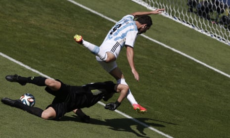 Iran's goalkeeper Alireza Haghighi bravely rushes off his line to deny Higuain.