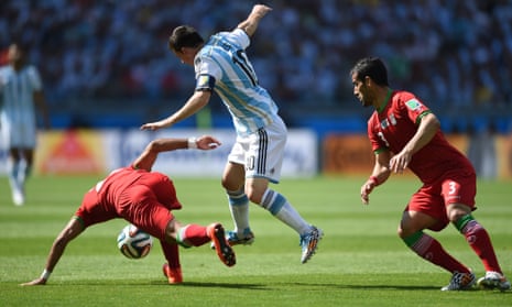 Mehrdad Pooladi and Ehsan Hajsafi try and stop Messi.