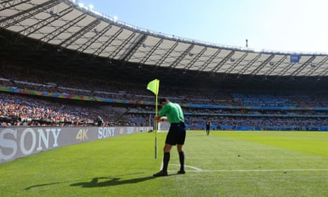 The referee puts the corner flag back in place.