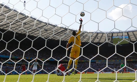 Argentina's goalkeeper Sergio Romero tips a header by Iran's Ashkan Dejagah over the bar.