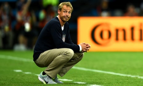 USA head coach Jurgen Klinsmann crouches on the sidelines.