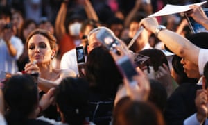 Actress Angelina Jolie signs autographs for fans as she makes her appearance at Japan's premiere of Maleficent in Tokyo