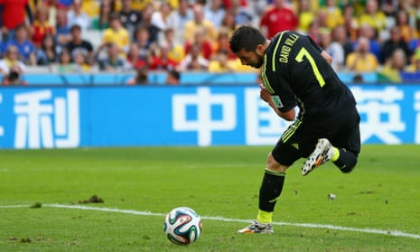 David Villa flicks the ball in with his right foot, 1-0 to Spain.