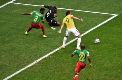 Cameroon's defender Nicolas Nkoulou and goalkeeper Charles Itandje watch the ball as Fred tries to connect.