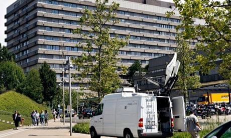 A satellite television van stands outside the University Hospital Lausanne
