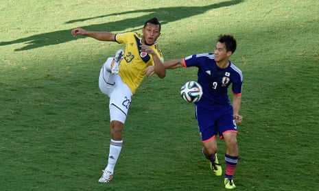 Japan's forward Shinji Okazaki (right) vies with Colombia's defender Carlos Valdes.