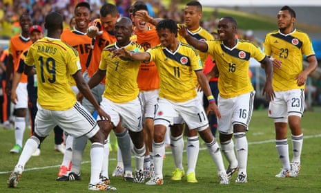 Juan Guillermo Cuadrado of Colombia celebrates with teammates after scoring with a penalty.
