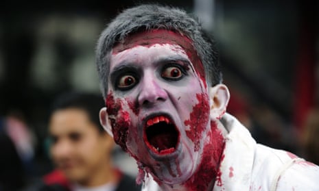 A man dressed up as a zombie takes part in a "Zombie Walk" at the Revolution Monument in Mexico City on November 3, 2012.