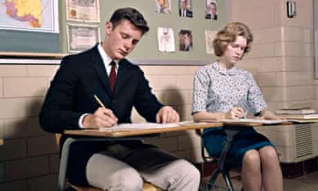 1960s man and woman taking tests at college desks