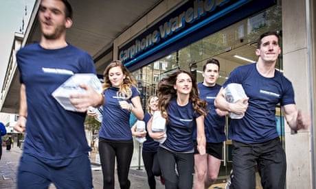 Runners in Carphone Warehouse livery run out of a store each holding a small parcel