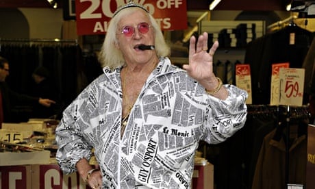 Jimmy Savile poses for the camera