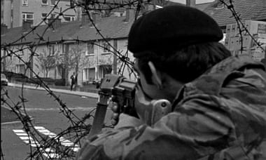 A British soldier aims his rifle on a suspect in the republican Ballymurphy estate in west Belfast.