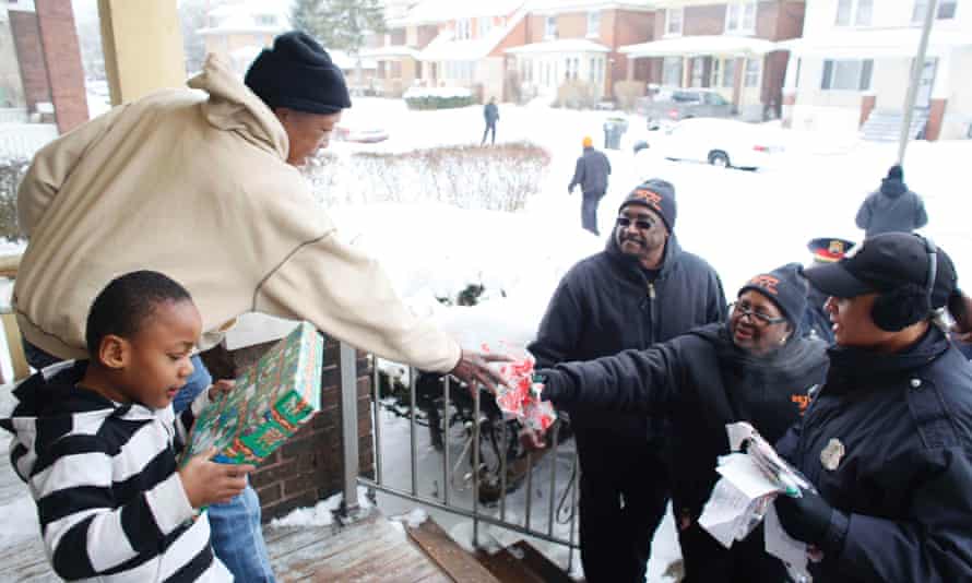 Members of Detroit 300 work with the police to bring some festive spirit to a poorer area of the city after a drugs raid.