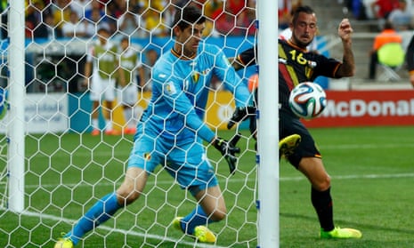 Belgium's Steven Defour and Thibaut Courtois keep the ball out.
