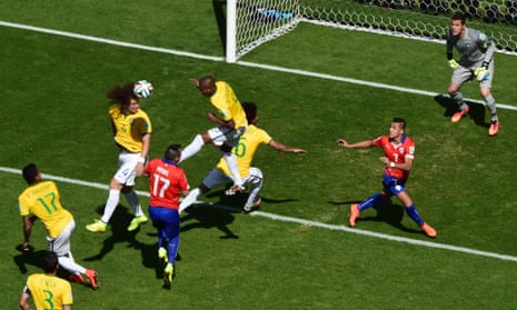 Brazil's defender David Luiz clears a Chile attack.
