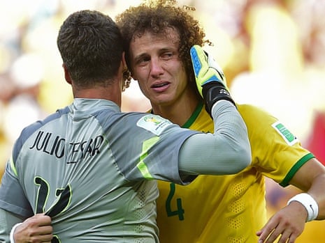 Brazil's defender David Luiz cries as he hugs his team's goalkeeper Julio Cesar after they won their match against Chile following a penalty shoot-out.