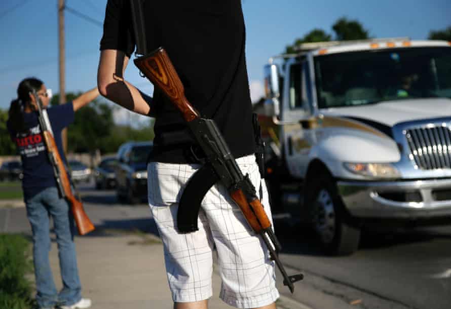 Kory Watkins, a coordinator for Open Carry Tarrant County carries his Romanian AK-47 over his shoulder during a demonstration.