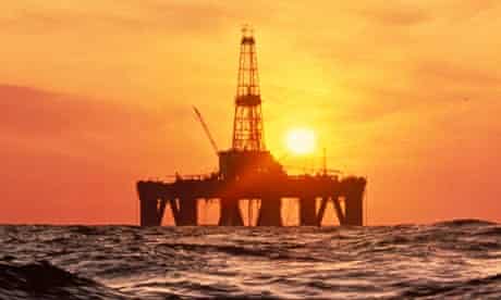 Offshore drilling rig with sunset in North Sea