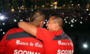 A handout picture provided by the Chilean FA showing Arturo Vidal, left, and Alexis Sanchez on the balcony of La Moneda government palace in Santiago after their elimination from the World Cup.