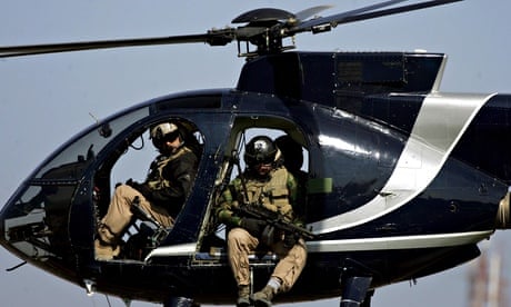 Blackwater security guards scan Baghdad from their helicopter