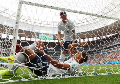 Raphael Varane is assisted by Mathieu Debuchy as lies hurt in the net.