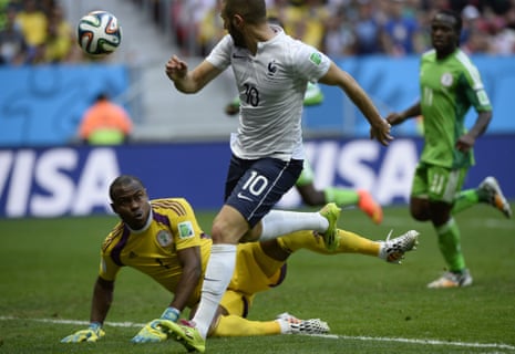 Karim Benzema chips the ball over Vincent Enyeama...