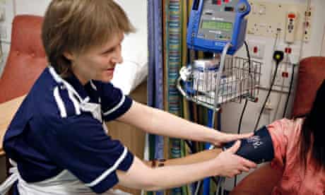 A nurse taking a patient's blood pressure at the Queen Elizabeth Hospital, Birmingham