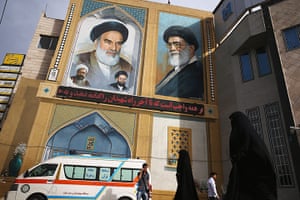 Agencies Iran Moore: Women walk past a portrait of the late Ayatollah Khomeini 