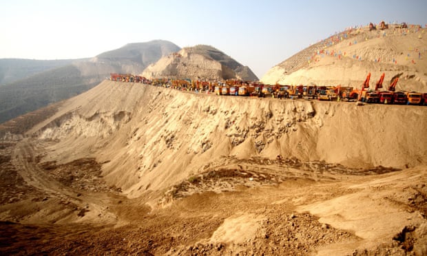 Construction machines are lined up on a mountain during the ground-breaking ceremony for the Lanzhou New Area project in Lanzhou city, northwest Chinas Gansu province, 26 October 2012. In what is being billed as the largest mountain-moving project in Chinese history, one of Chinas biggest construction firms will spend GBP 2.2 billion to flatten 700 mountains levelling the area Lanzhou, allowing developers to build a new metropolis on the outskirts of the northwestern city.