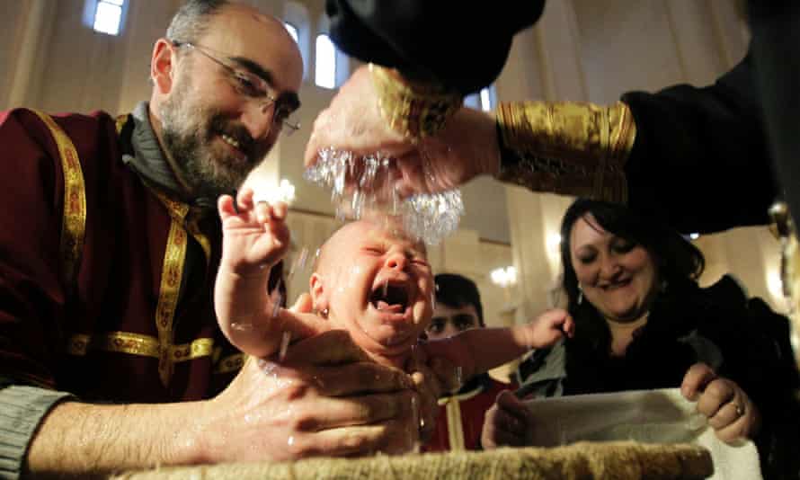 A baby is baptised during a mass baptism ceremony by the Georgian Orthodox church in Tbilisi in 2012.