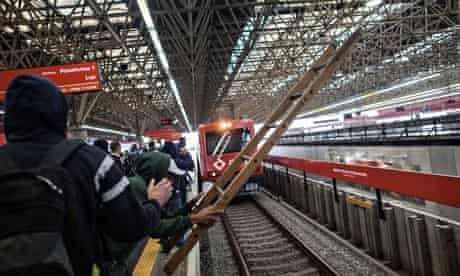 Commuters invade subway tracks in station closest to Itaquerao stadium during the strike