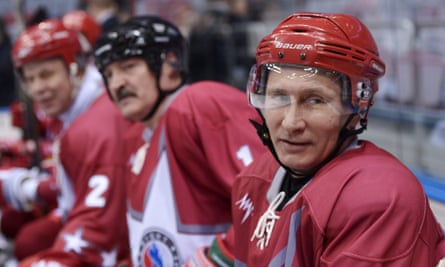 Russian President Vladimir Putin (R) and Belarusian President Alexander Lukashenko (C) attend an ice hockey match at the ice hockey palace in Sochi, Russia, this year.