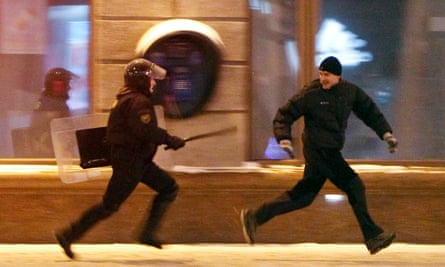 A riot policeman chases an opposition protester during a rally denouncing the results of the 2010 election in Minsk December.