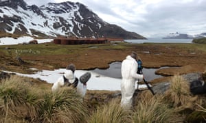 Tom Beard and Will Anderson filming at Leith Harbour, South Georgia. Due to the asbestos that riddles the station, the crew had to wear protective suits, and face masks when in high-risk buildings.