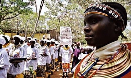 Demonstrators against female genital mutilation march through the village of Marich Pass in Kenya