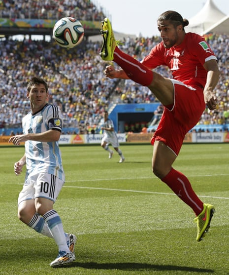 Ricardo Rodriguez uses his long legs to thwart little Lionel Messi.