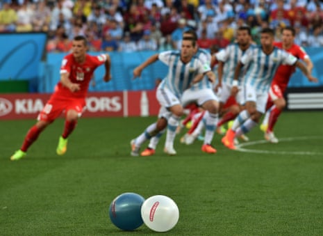 Some balloons in the colours of Argentina lay on the pitch as a free-kick is whipped in.