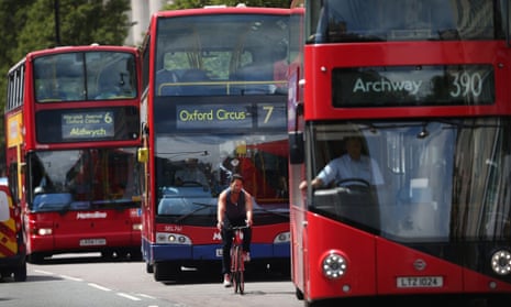 A cyclist passes buses in Oxford Street, London. The city is one of several UK urban areas in breach of EU pollution limits for nitrogen dioxide