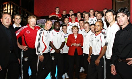 German Chancellor Angela Merkel poses with the German national team