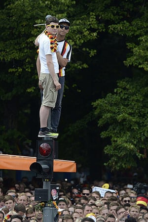 victory parade: Two German fans stand atop traffic lights