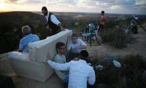 Israelis gather to look at the Gaza Strip from a hilltop near the southern town of Sderot.