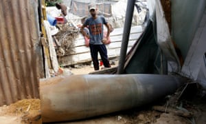 A Palestinians looks at a rocket launched by Israeli forces. gaza