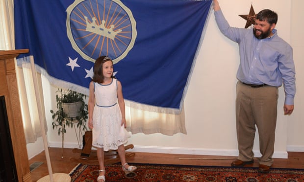 Jeremiah Heaton and his seven year-old daughter Emily, with the flag their family designed.