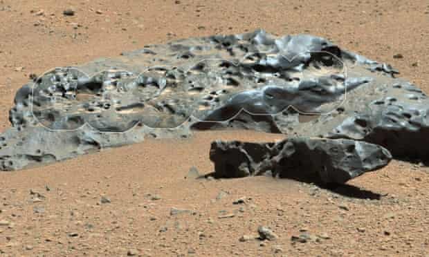 A large iron meteorite lies on the surface of Mars.