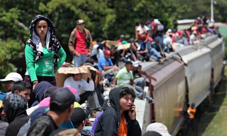 Migrants ride north on top of 'la bestia', heading for the US border.