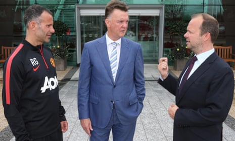 New Manchester United manager Louis van Gaal oses with assistant manager Ryan Giggs and executive vice-chairman Ed Woodward at the club's training complex.